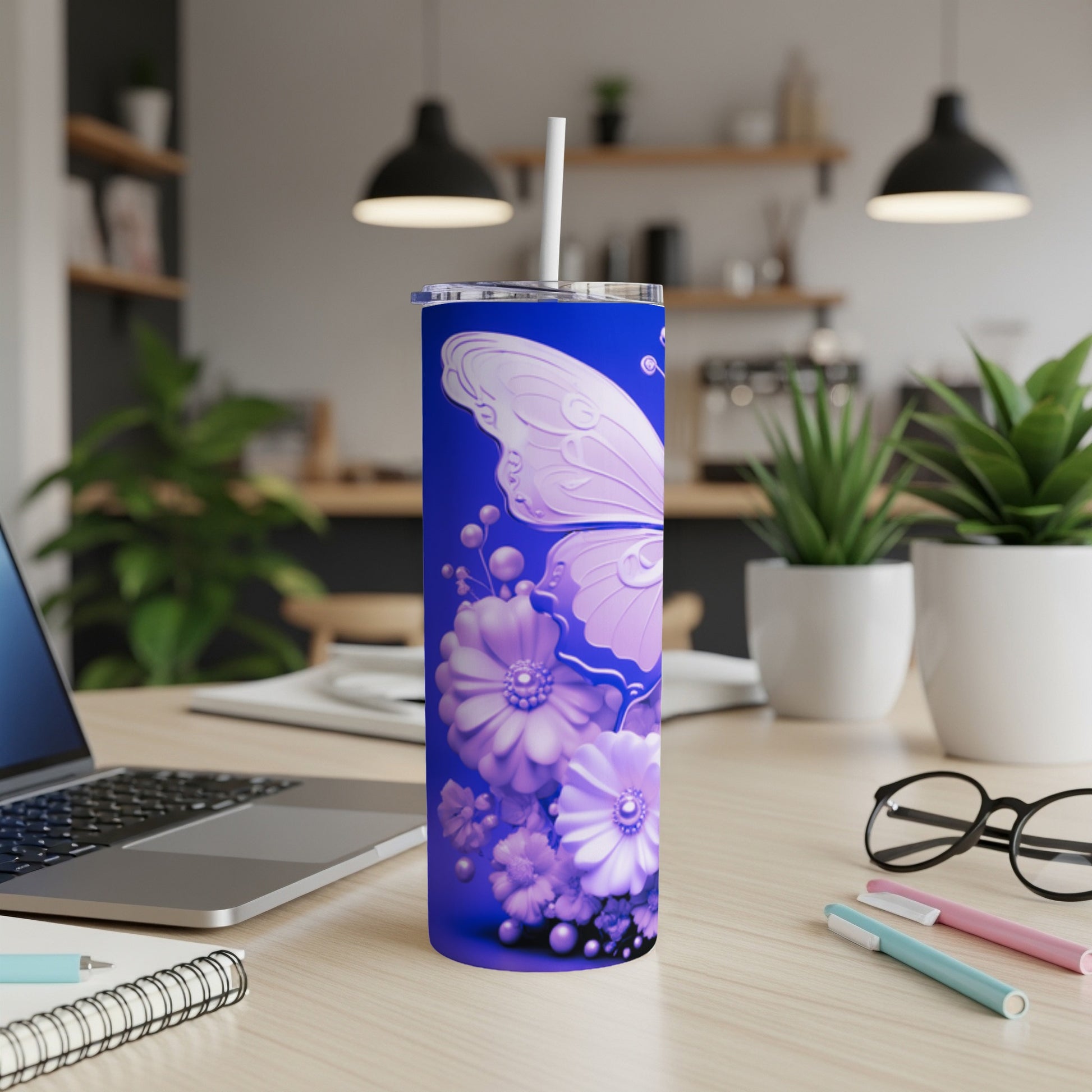 Purple butterfly and floral design on a blue tumbler with a straw.