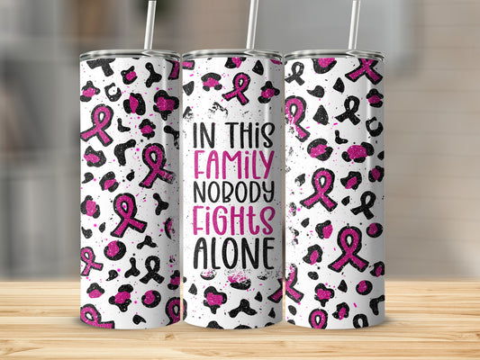White tumbler with pink ribbon pattern and text "In this family nobody fights alone".