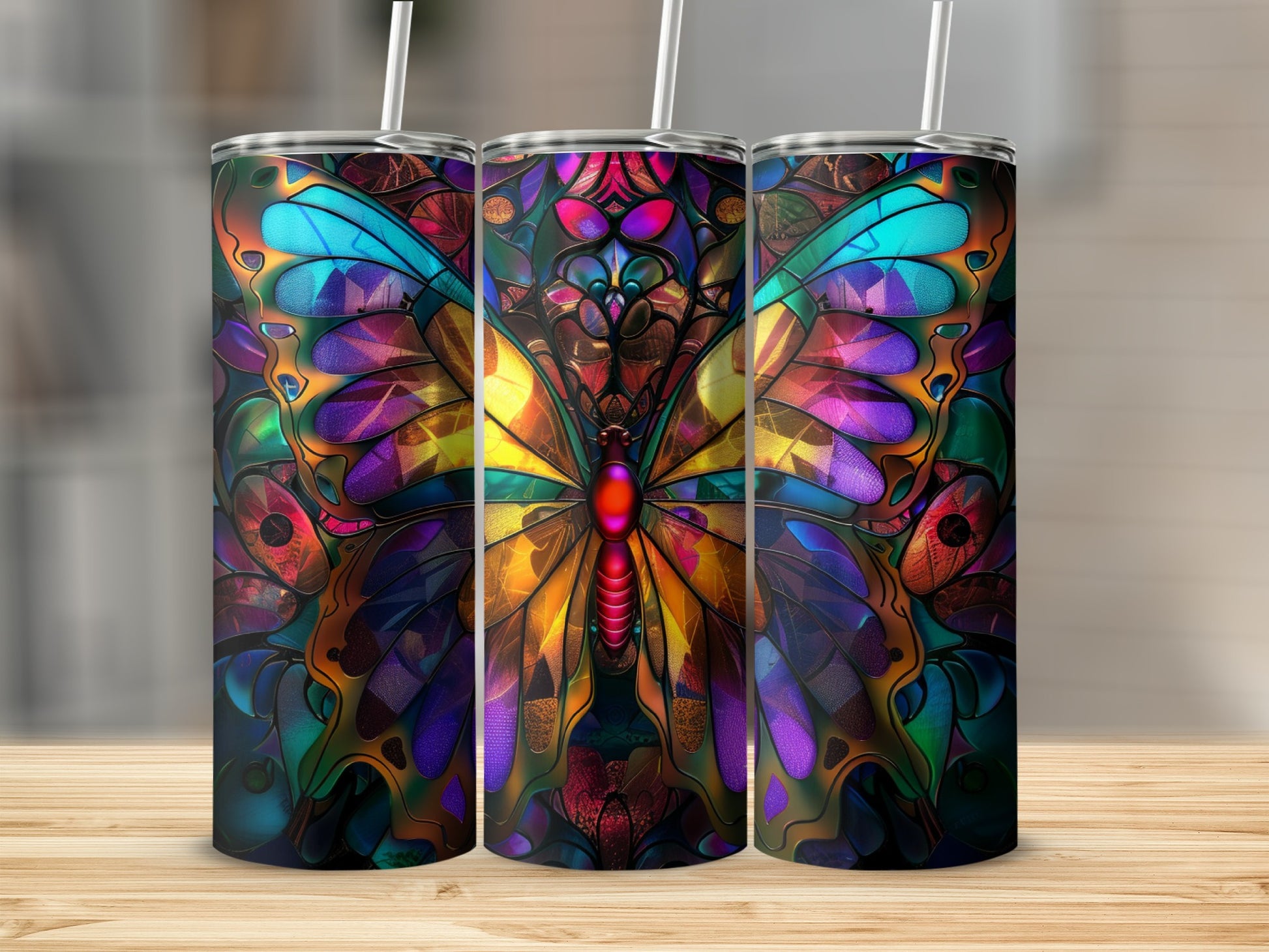Triptych of tumblers with stained glass butterfly and floral patterns.