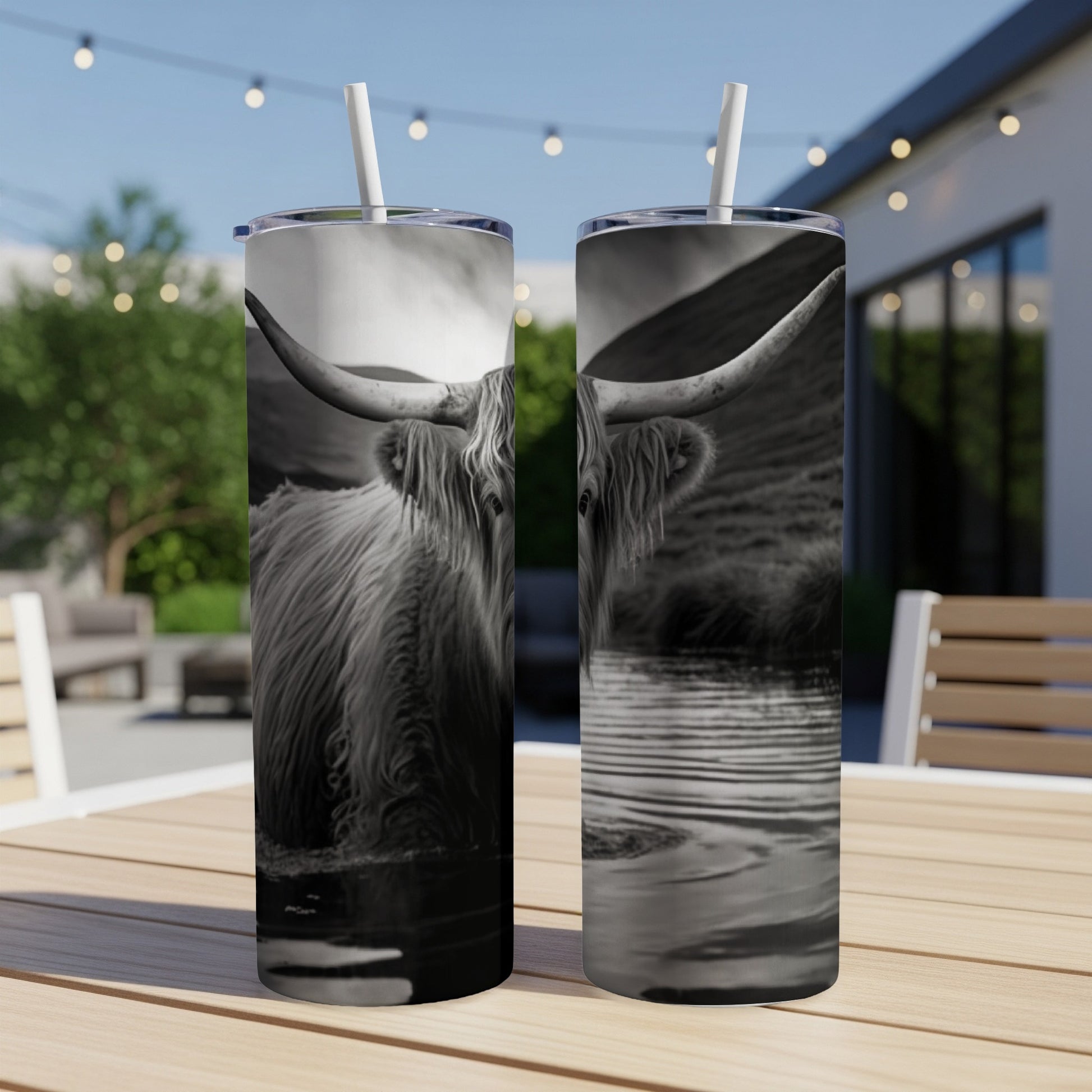 Black and white Highland cow in water on two tumblers.