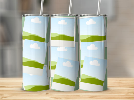 Three tumblers with a green and white landscape design and white straws.