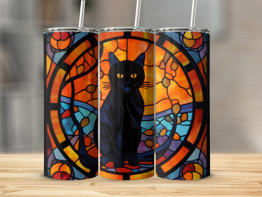 Black cat with yellow eyes against stained glass pattern on a tumbler.