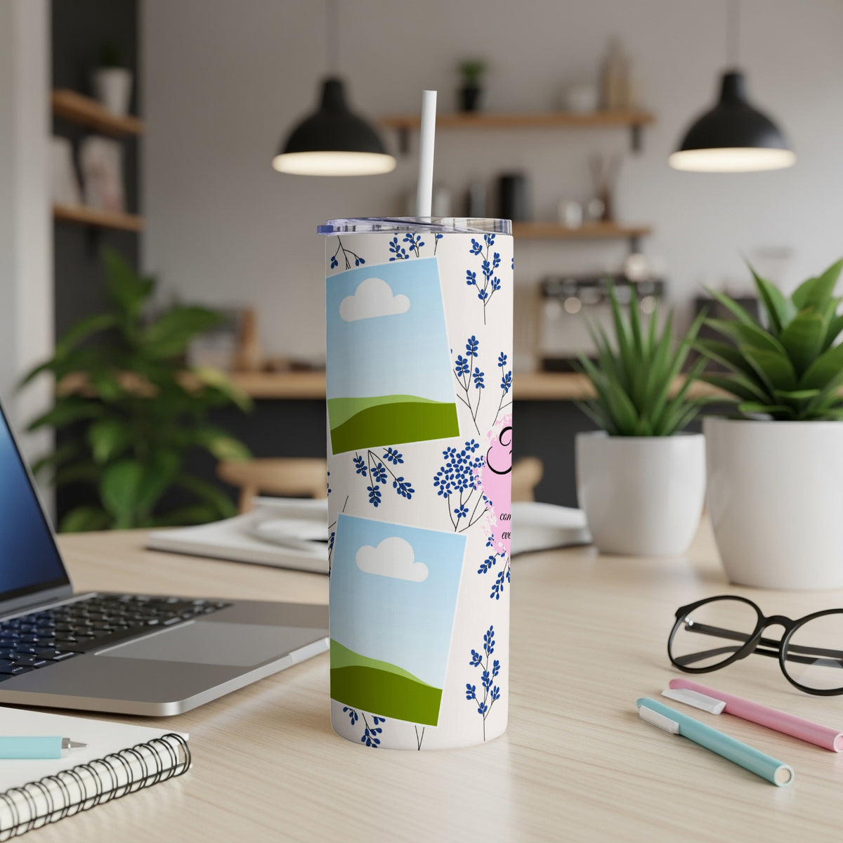 Tumbler with photos, blue flowers, and pink lettering on a desk.