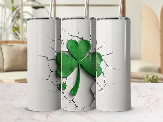 Three white tumblers with green shamrock design cracking through surface.