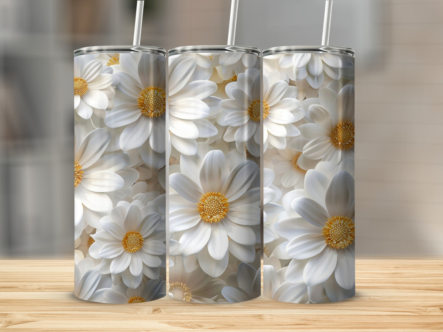 Three white daisy tumblers with straws on a wooden surface.