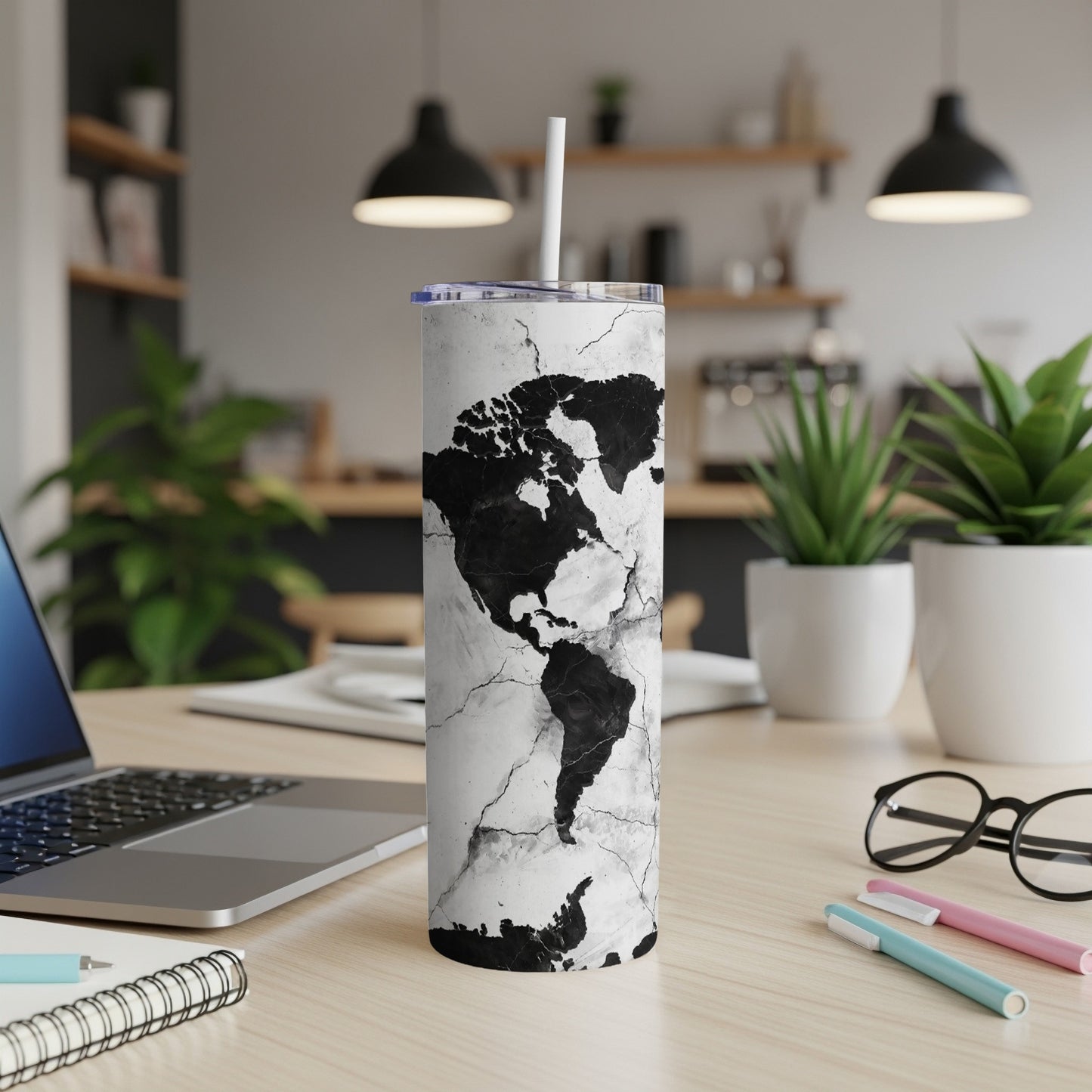 Tumbler with black and white cracked earth design and a white straw.