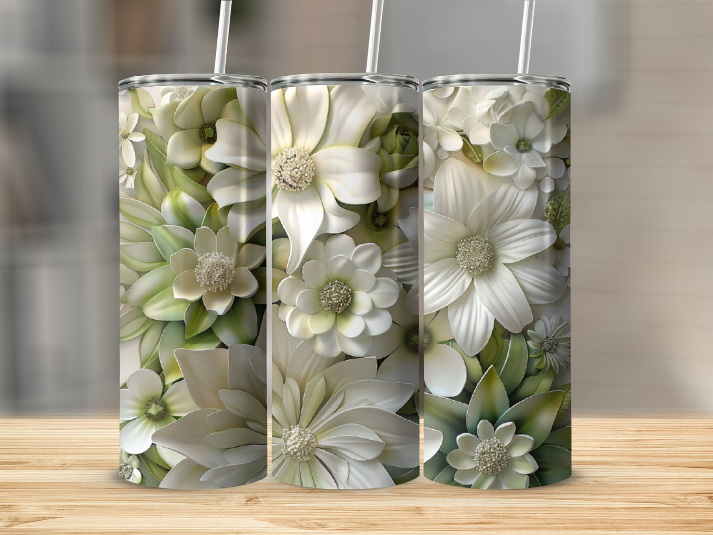 Three tumblers decorated with white and green floral designs.