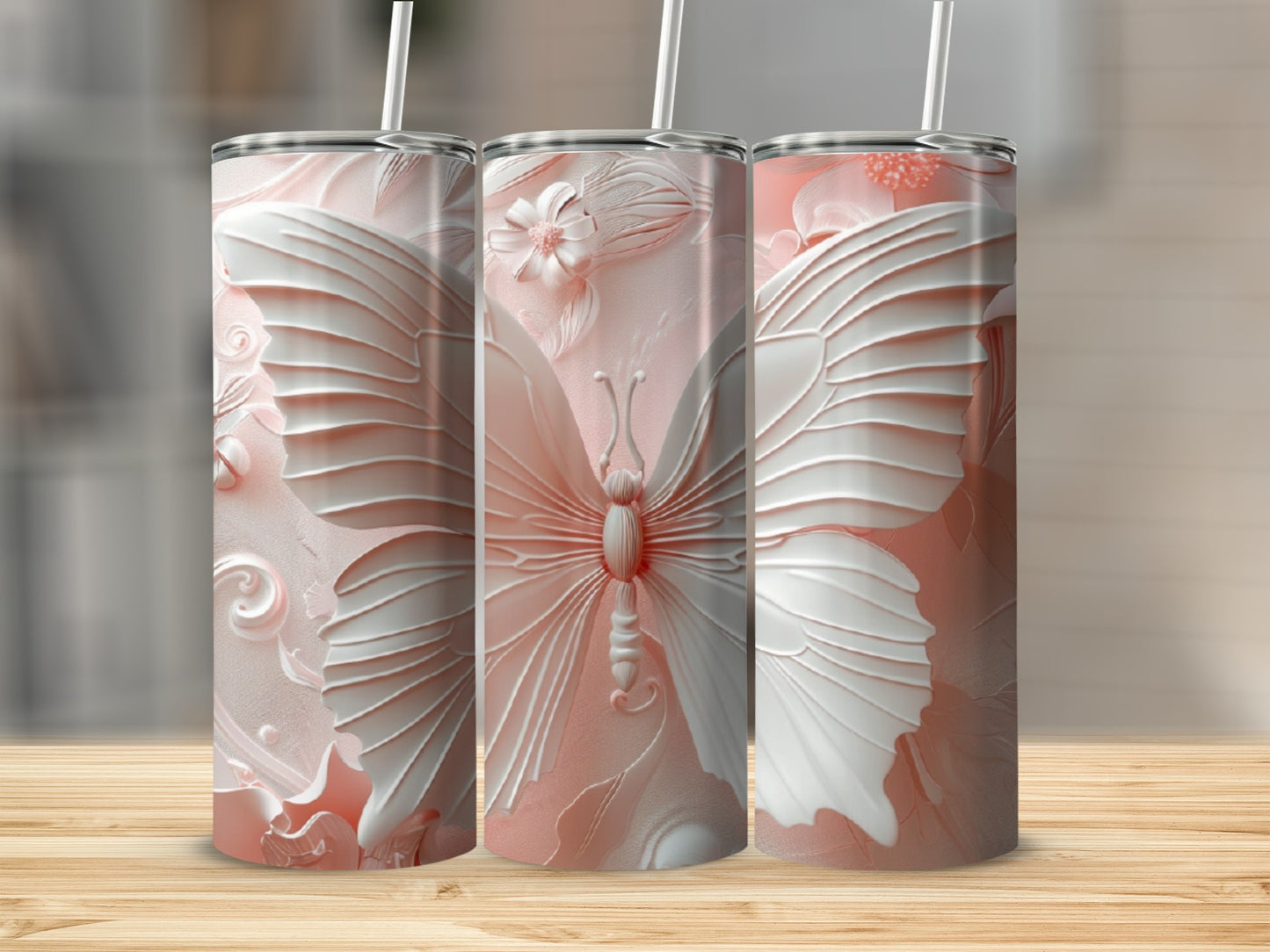 Three pink tumblers with embossed butterfly and floral designs.
