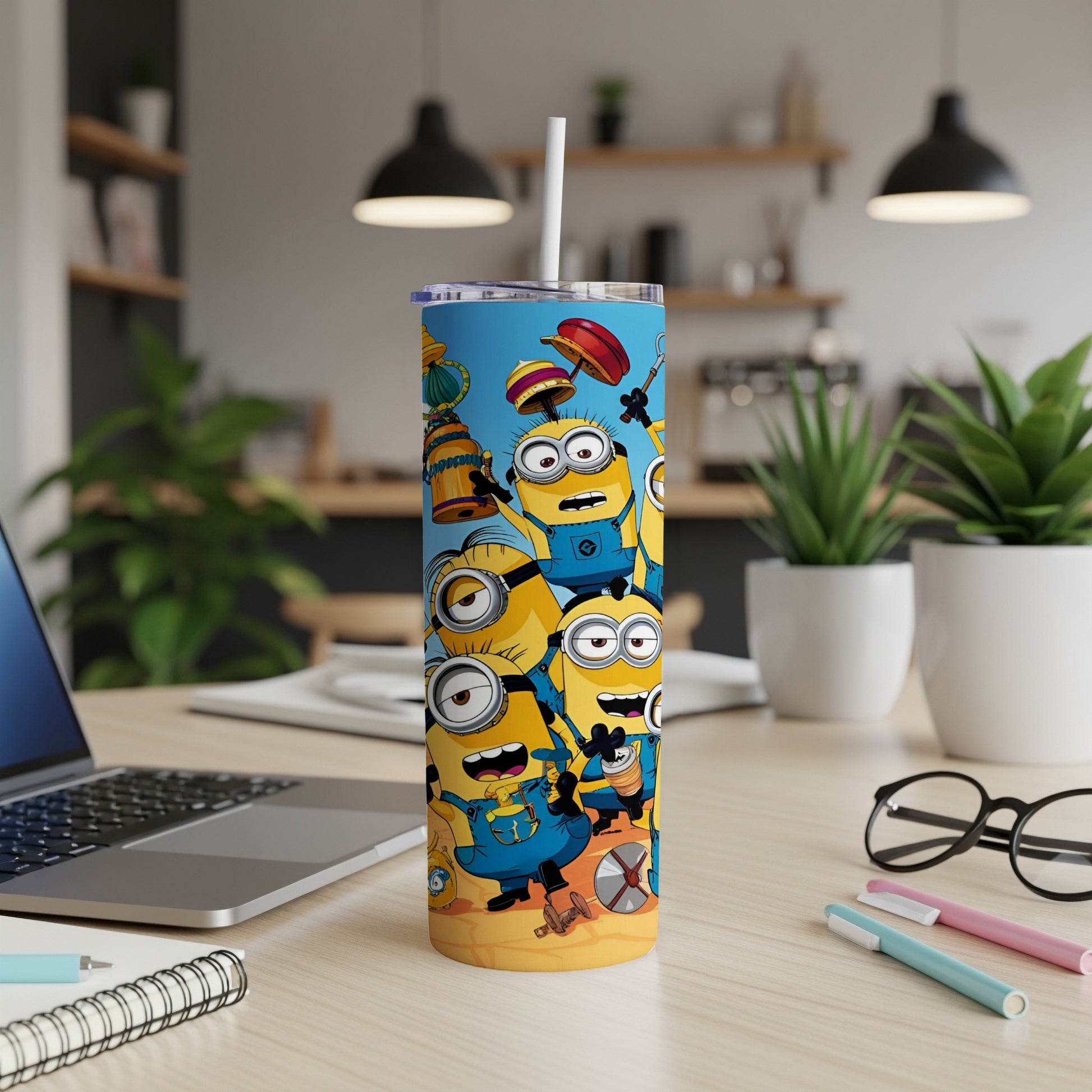 Minions on a beach scene with straw in a tumbler cup.
