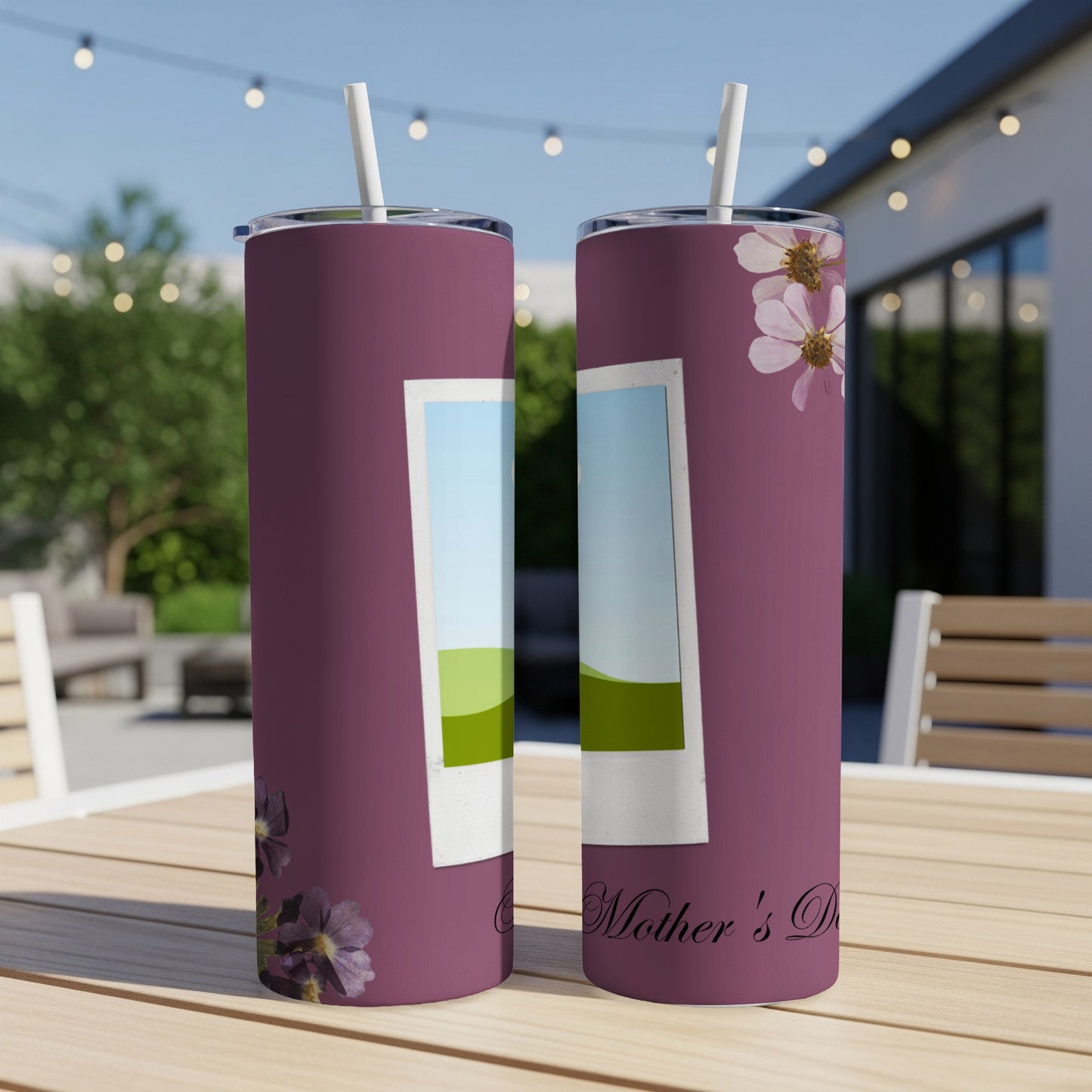 Two purple tumblers with faux polaroid frames and floral designs on a wooden table.