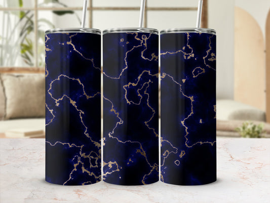 Dark blue tumbler with gold marble pattern and straw.