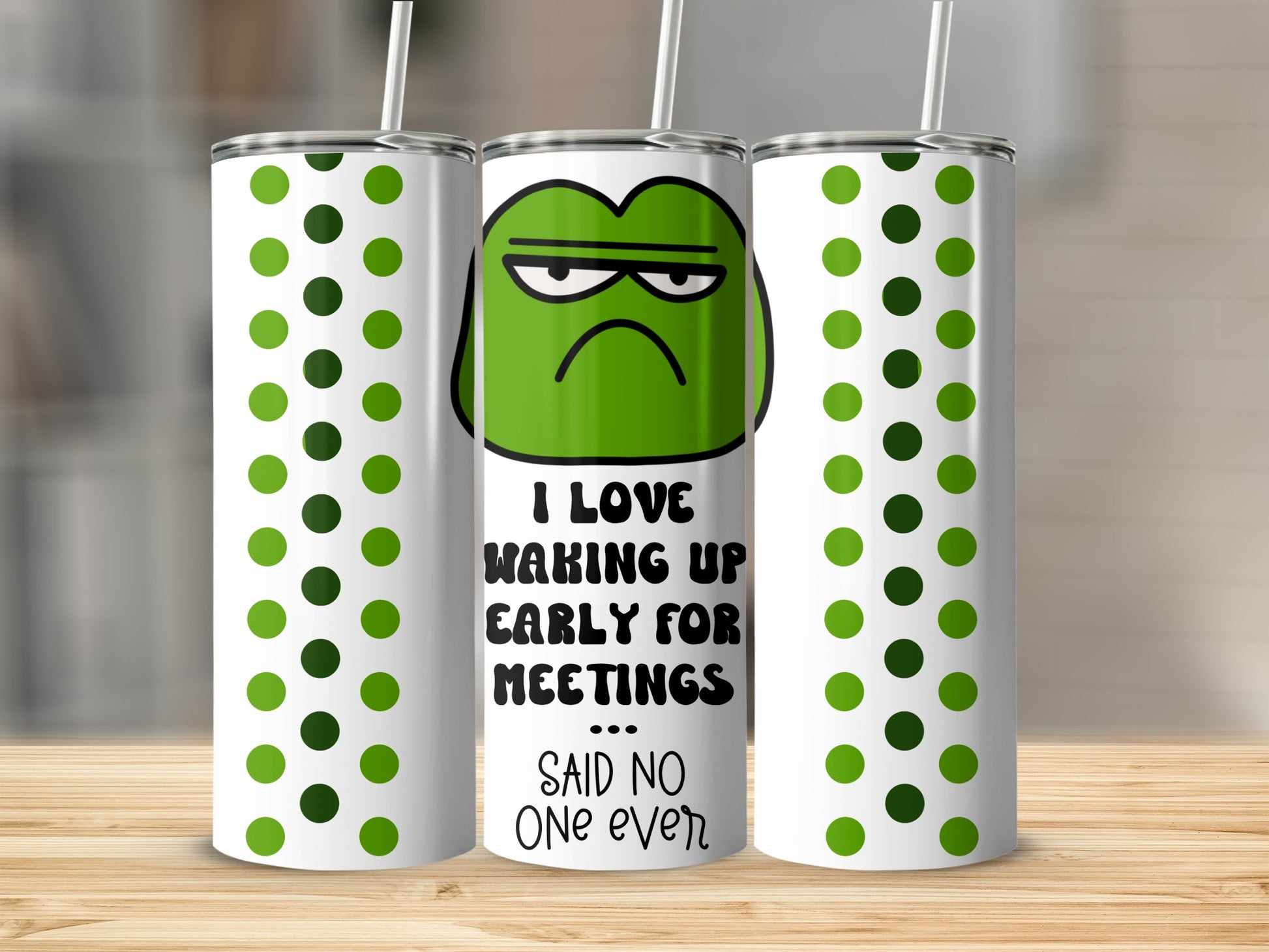 Green tumbler with grumpy face and text "I love waking up early for meetings said no one ever".