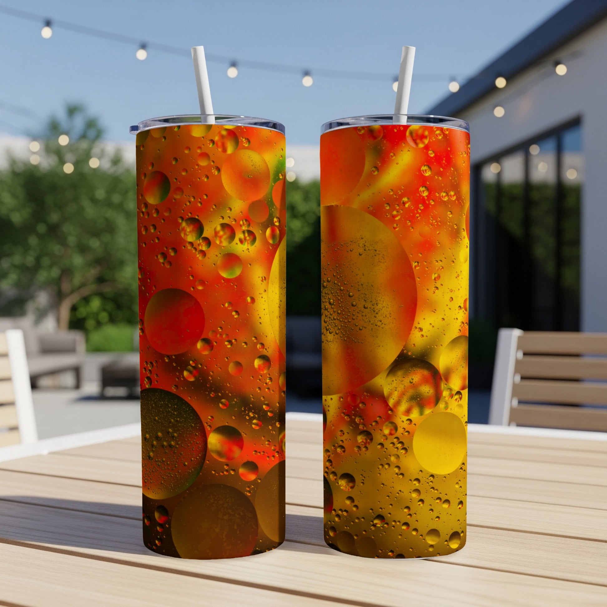 Two tumblers with oil and water bubble pattern in warm sunset colors.
