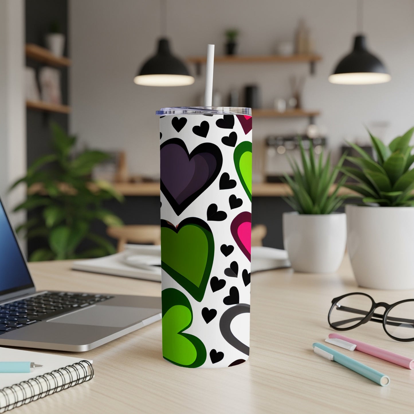 White tumbler with a repeating pattern of colorful hearts and black hearts.