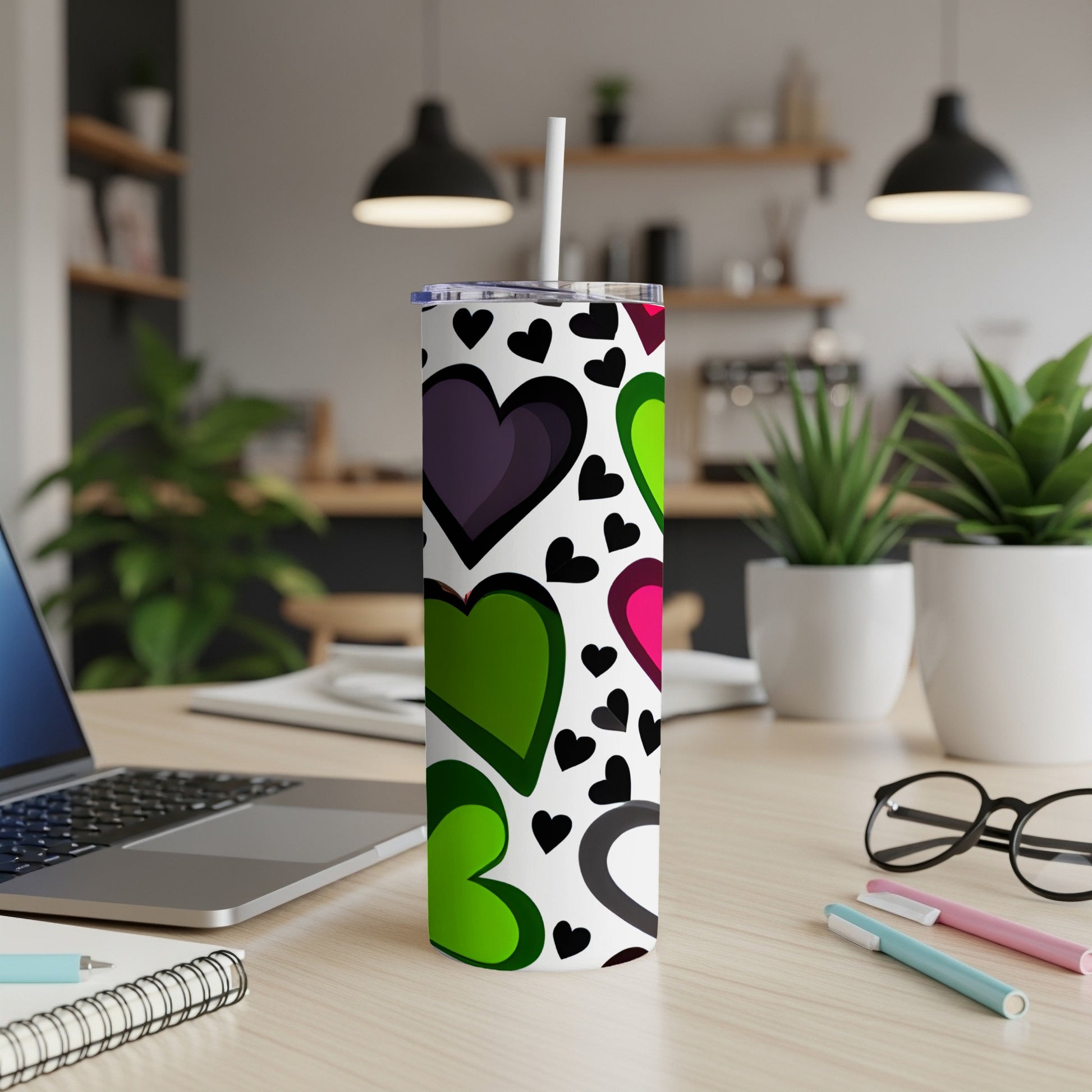 White tumbler with a repeating pattern of colorful hearts and black hearts.
