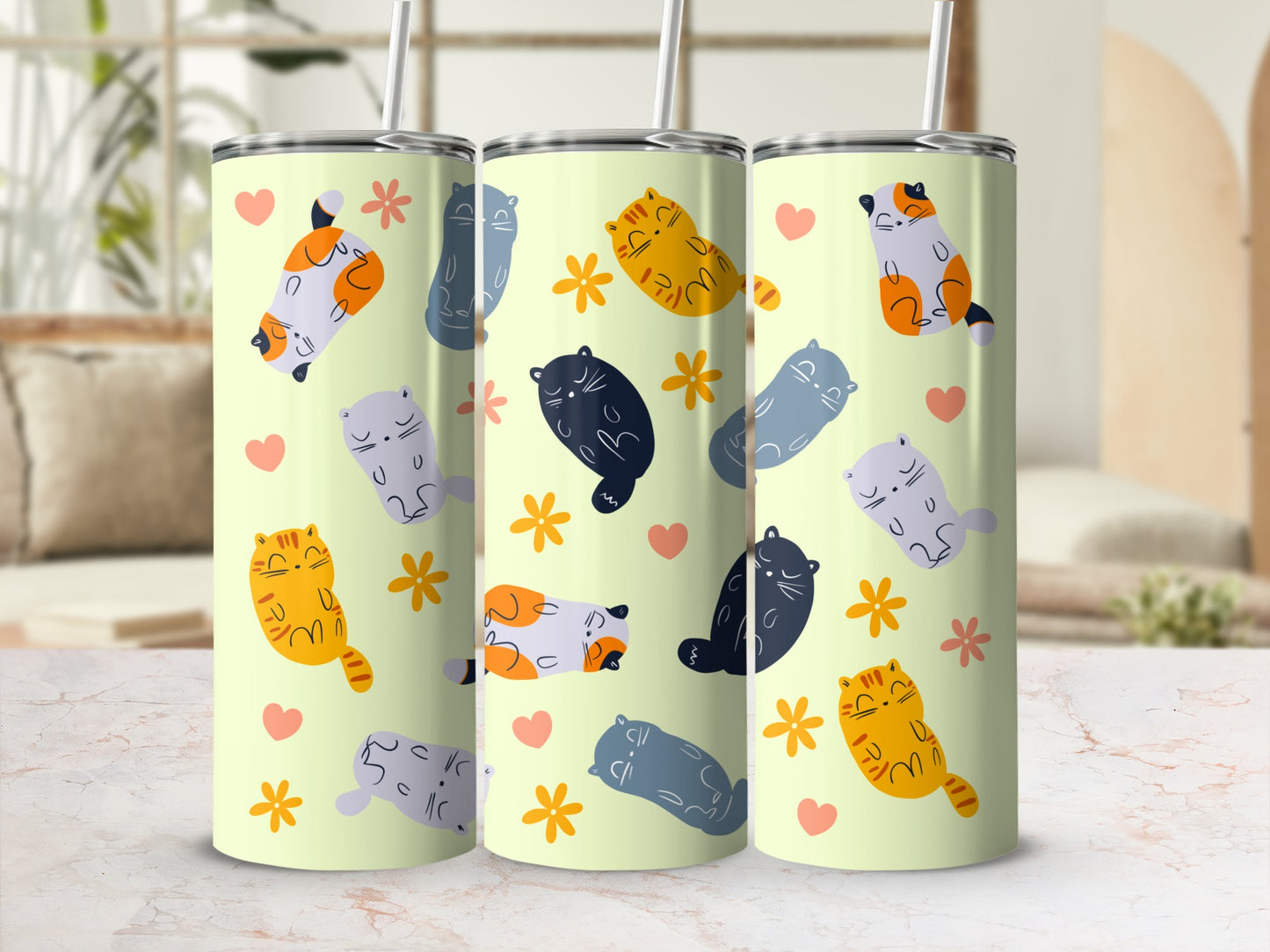 Three tumblers with light yellow background featuring cartoon cats and flowers.