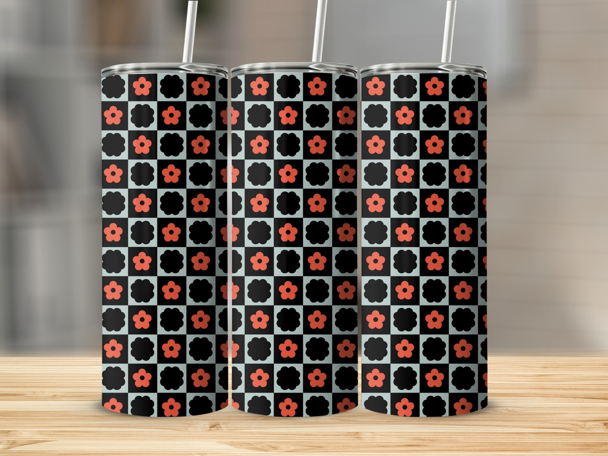 Three tumblers with black and red checkerboard floral pattern.