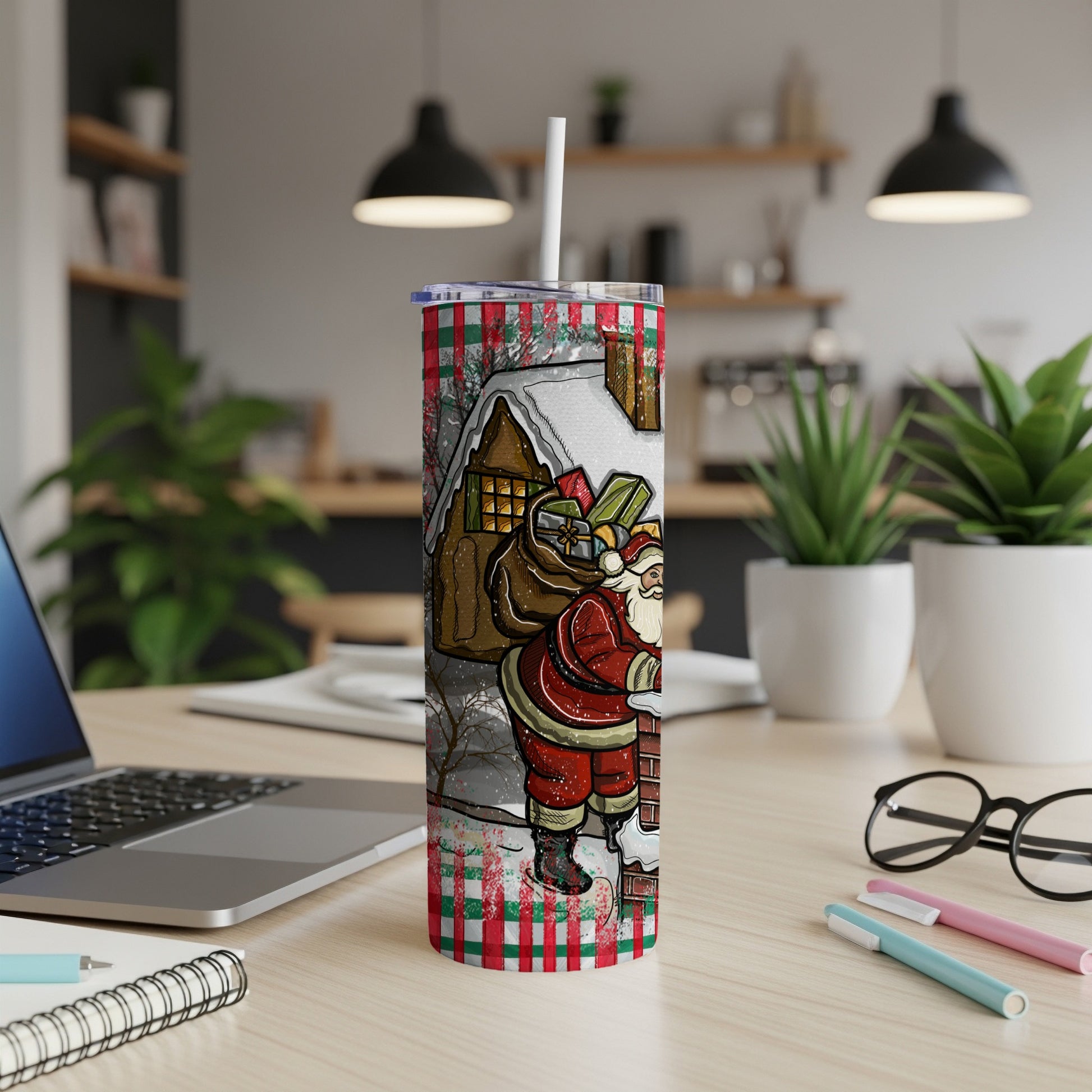 Santa Claus climbing a chimney on a festive Christmas tumbler cup.