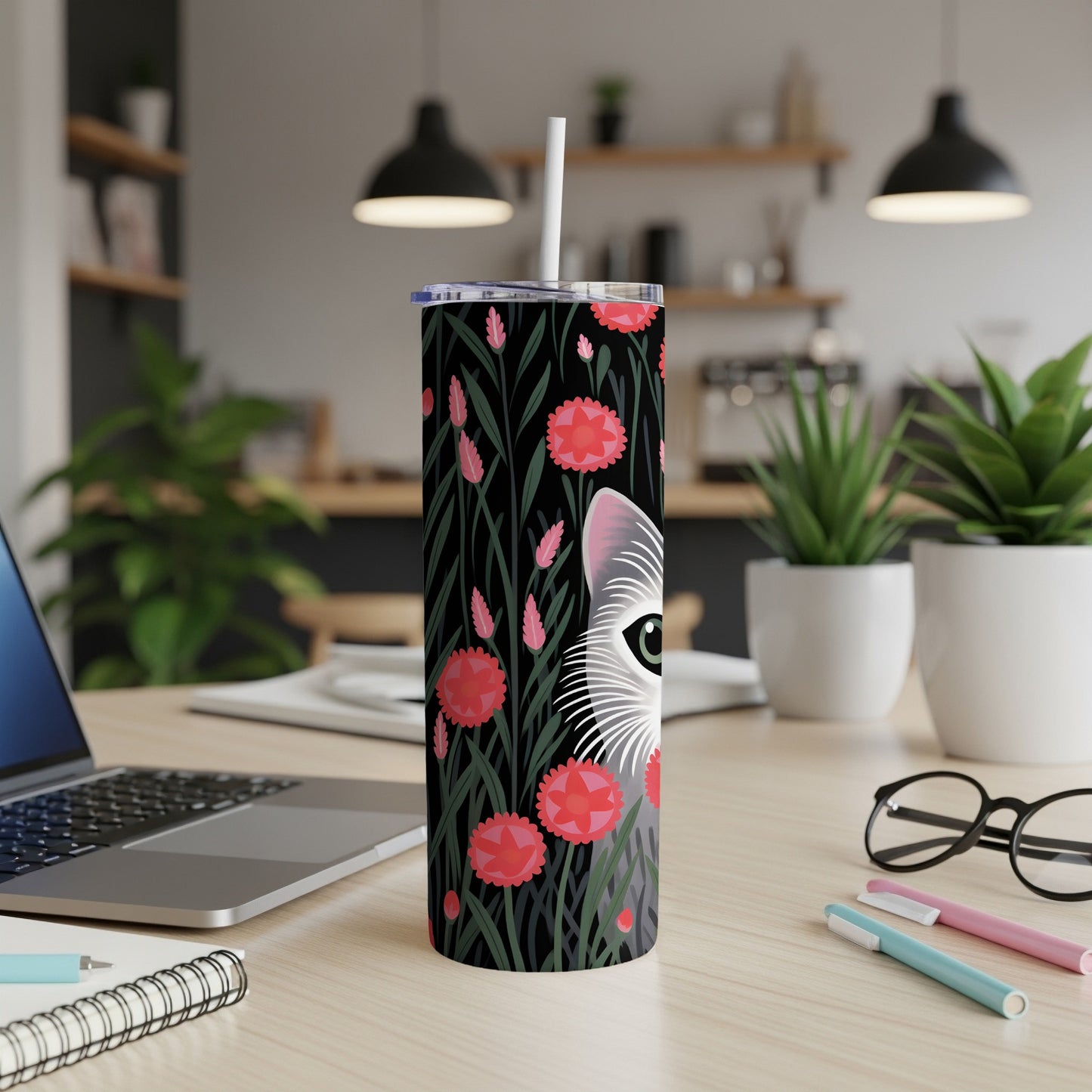 White cat with pink flowers on a black background on a tumbler.