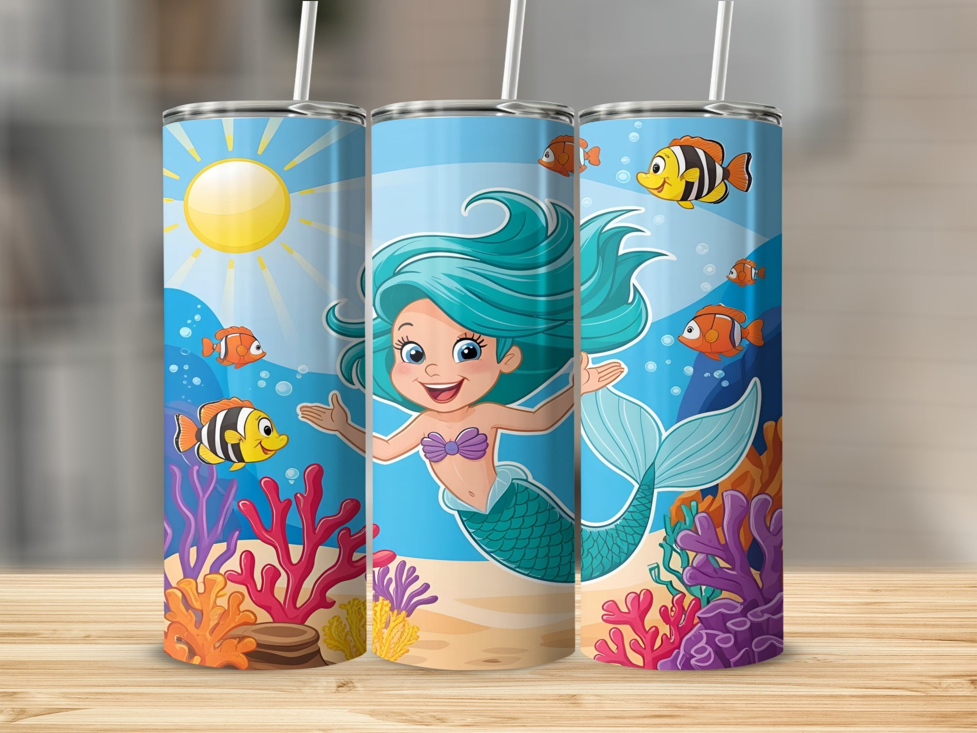 Blue tumbler with cartoon mermaid and colorful coral reef.
