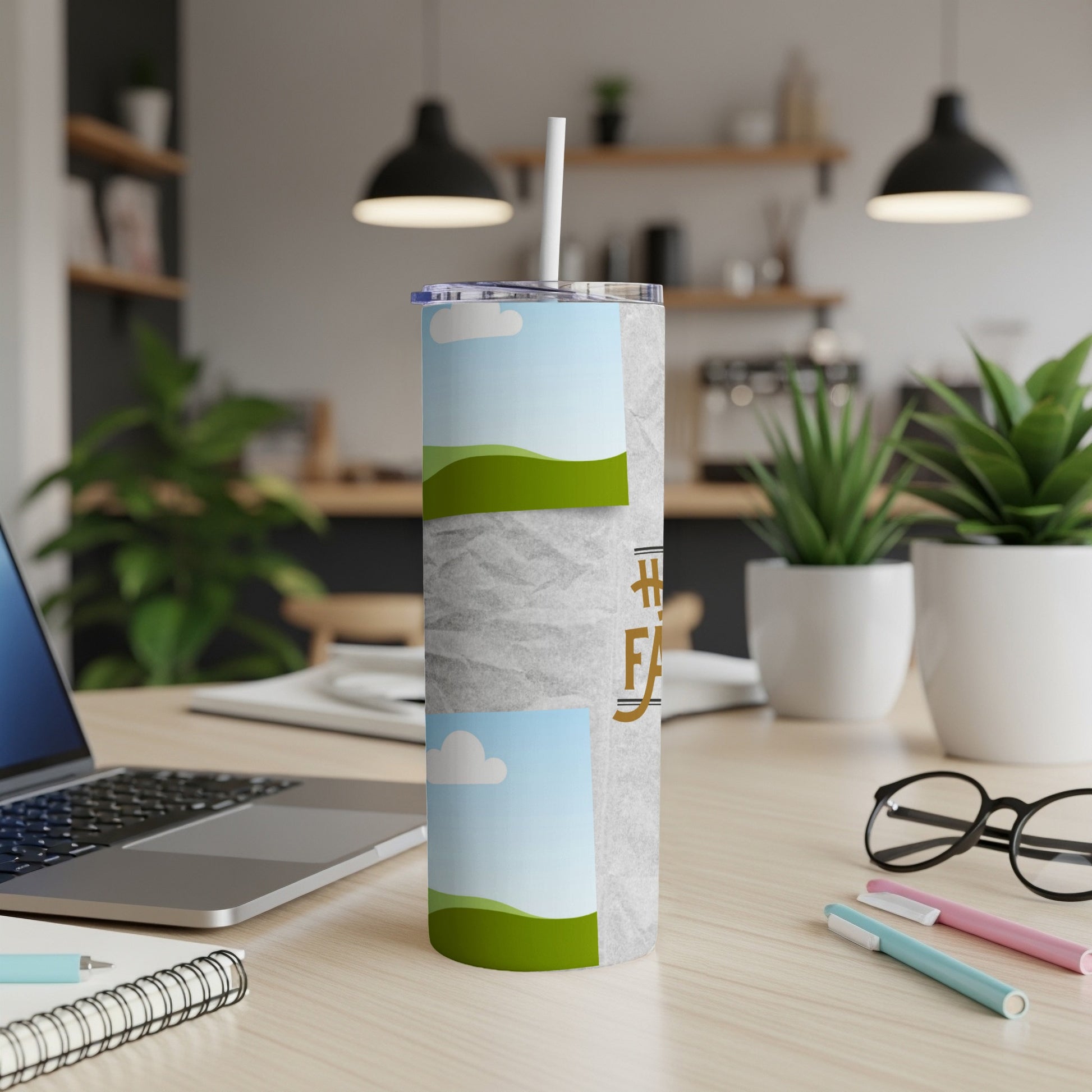 Tumbler with landscape photos and "#HappyFarmer" text on a desk with laptop.