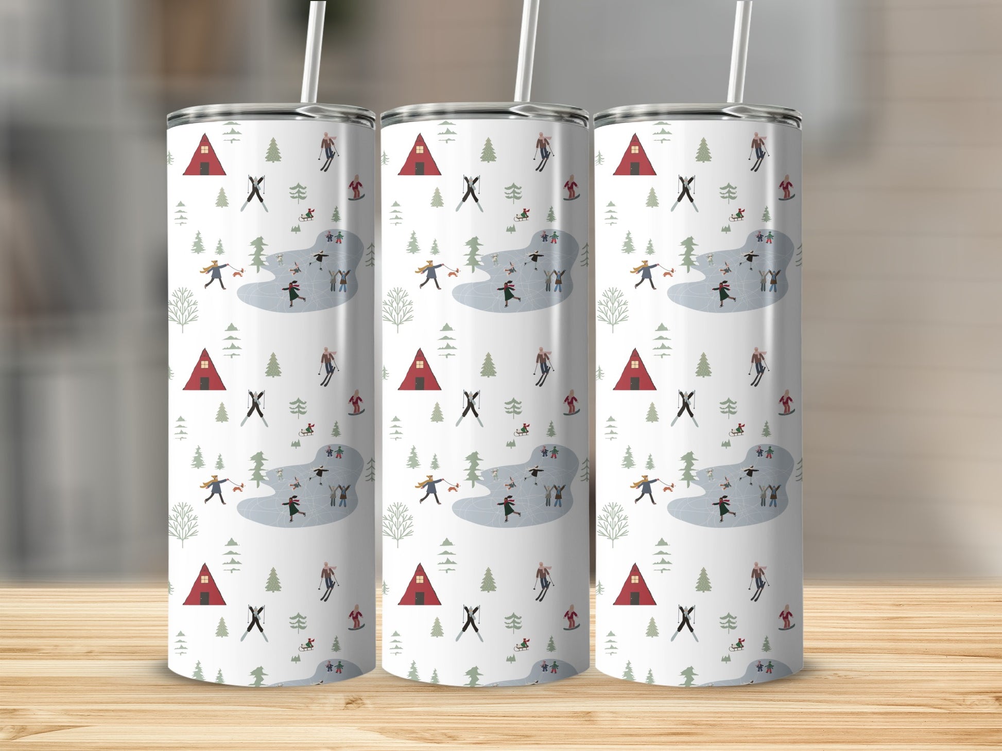 Winter scene tumbler with ice skaters, trees, and small houses.