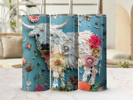White Highland cow with floral and butterfly accents on a teal tumbler.