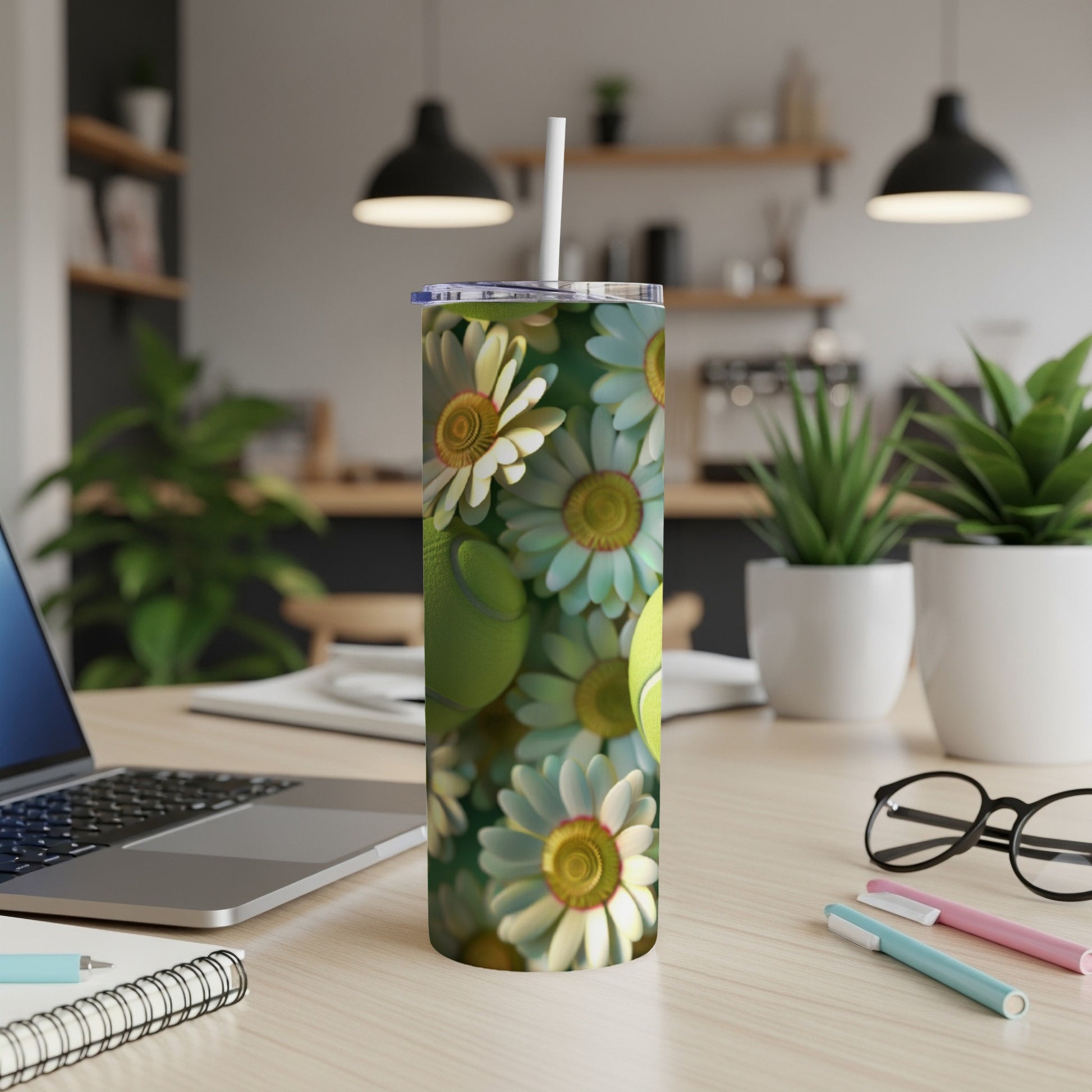 White and yellow daisies and green tennis balls pattern on a stainless steel tumbler.