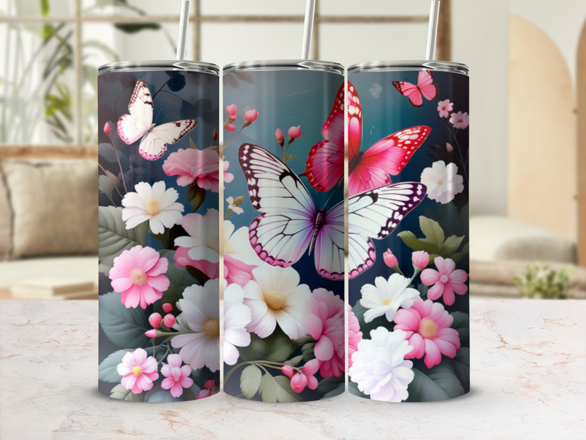 Three tumblers adorned with pink and white butterflies and flowers on a teal background.