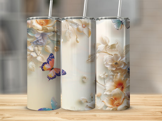 Three tumblers with floral and butterfly designs on a wooden surface.