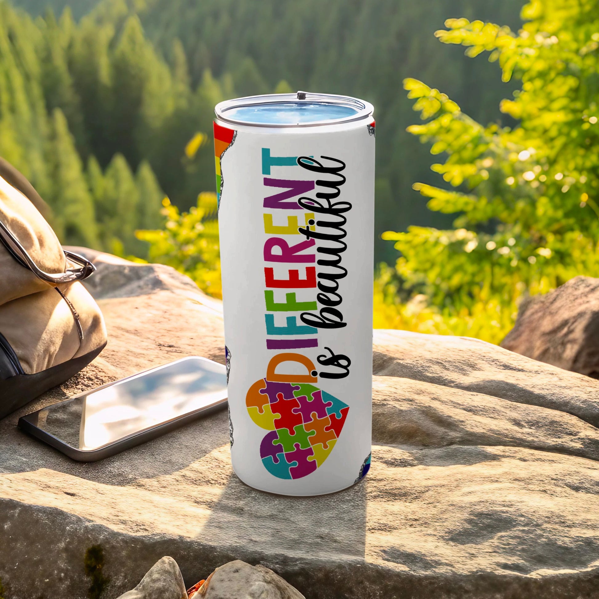 White tumbler with colorful puzzle heart pattern and "DIFFERENT is beautiful" text.
