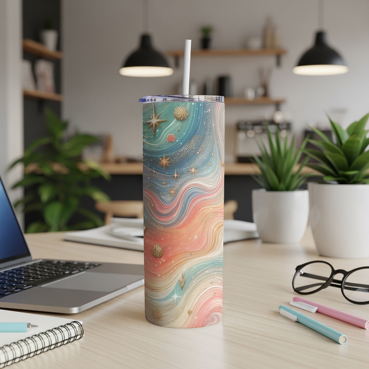 Tall tumbler with a swirling pastel cosmic design and a white straw.