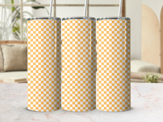 Three tumblers with orange and white checkered pattern and straws.