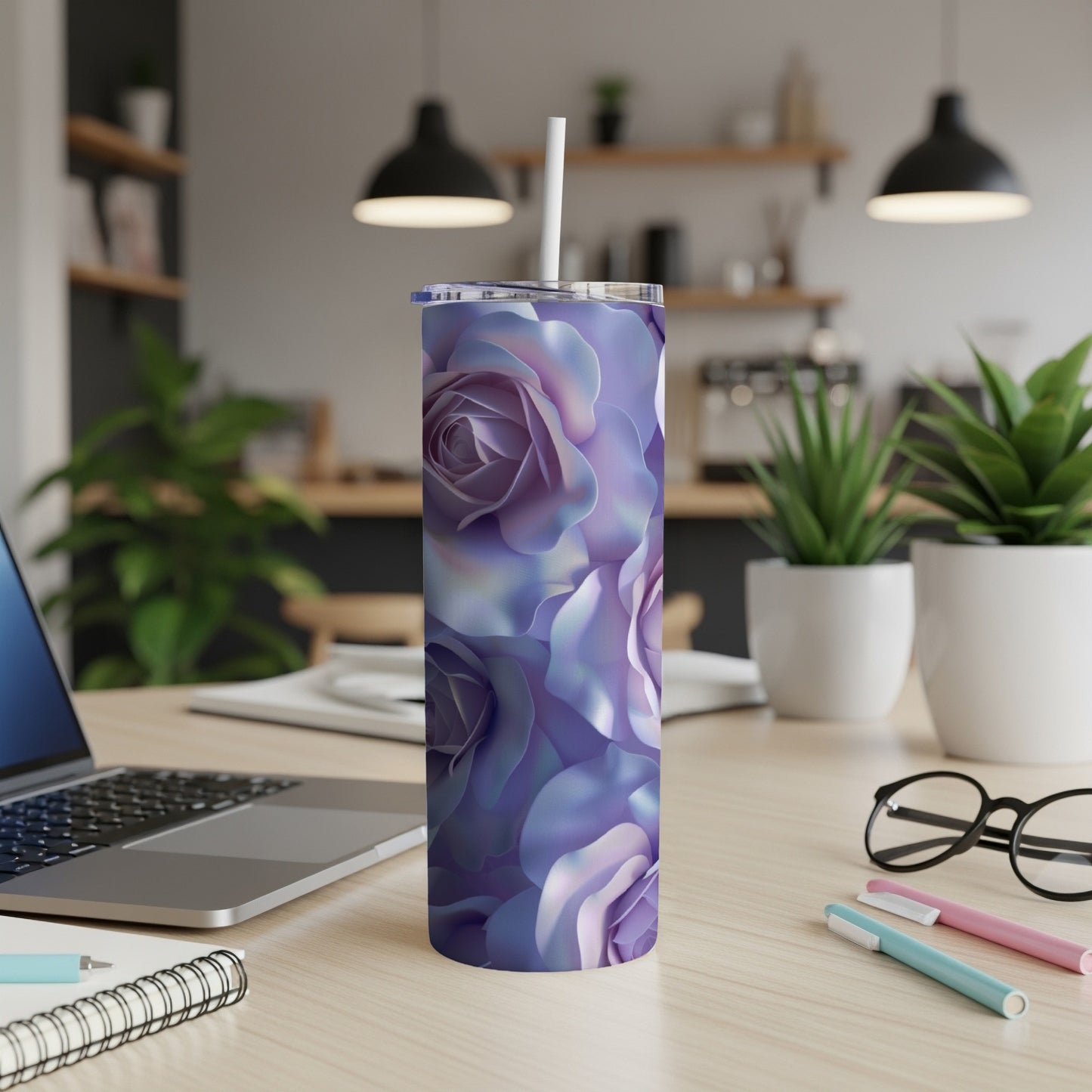 Purple floral tumbler with straw on a desk.