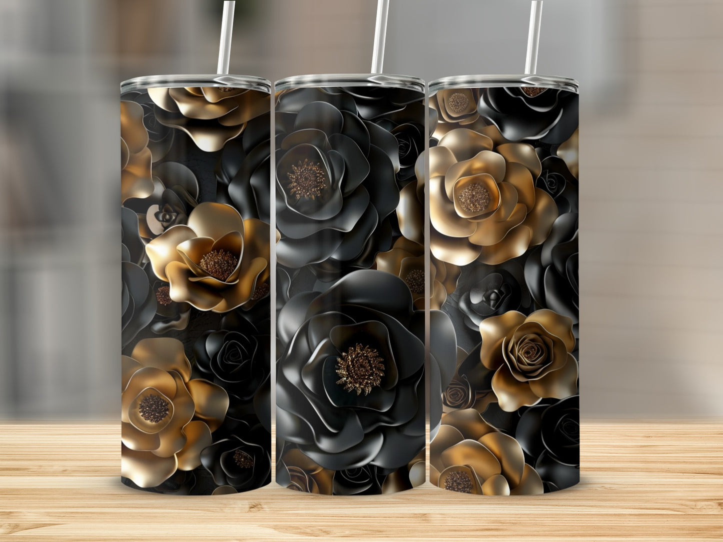 Three tall tumblers with dark and gold floral patterns on a wooden surface.