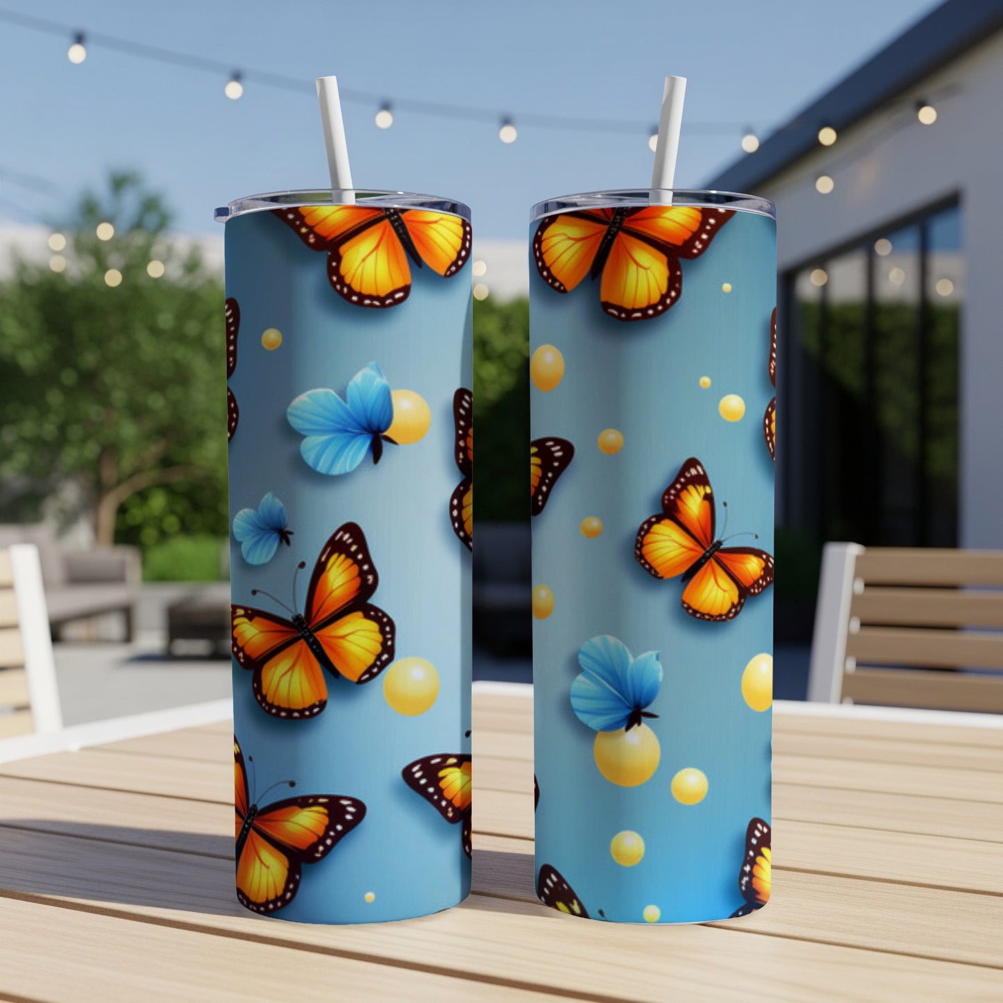 Two light blue tumblers with orange and blue butterflies and yellow dots pattern.
