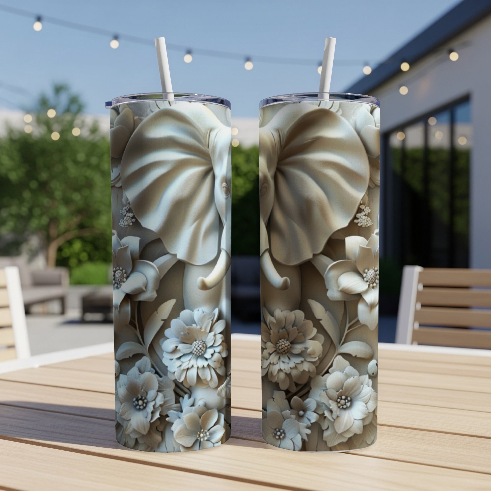 Two tall tumblers with embossed elephant and floral designs.