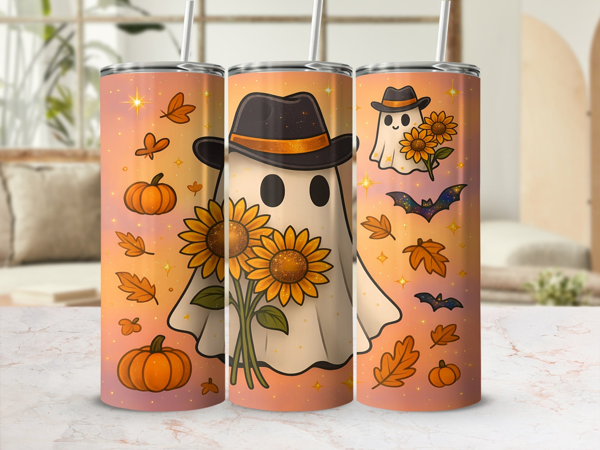 Three tumblers with autumn-themed ghost and sunflower designs on an orange gradient background.