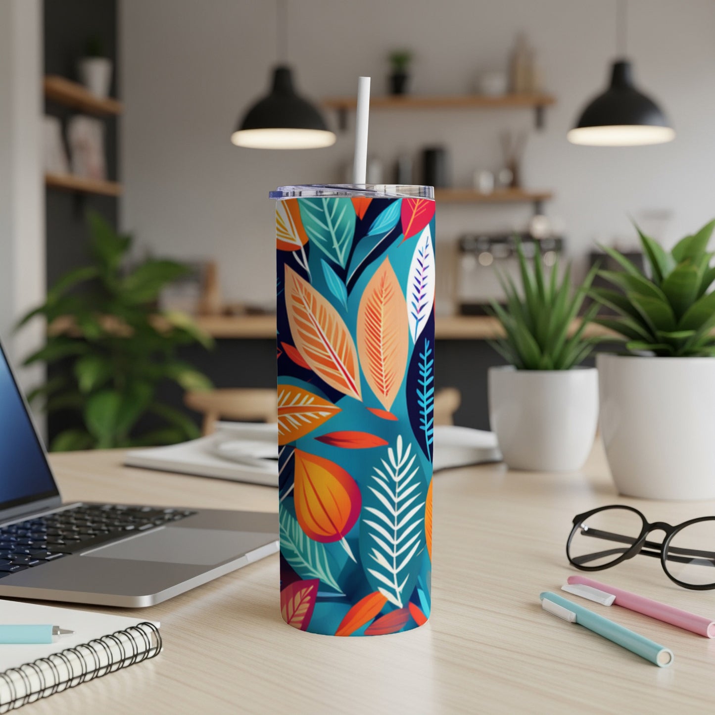 Tall tumbler with colorful abstract floral and leaf pattern, white straw.