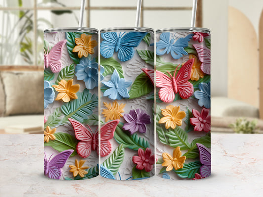 Three tumblers with colorful 3D butterflies and flowers.