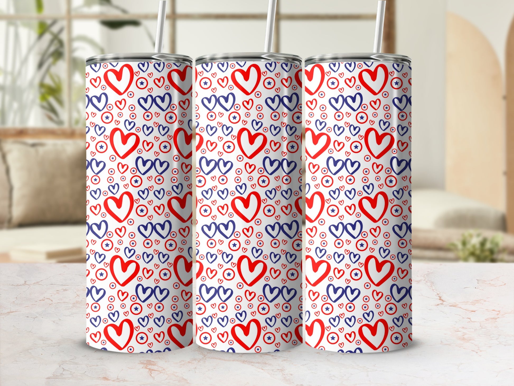 Three tumblers with a red and blue heart and star pattern.