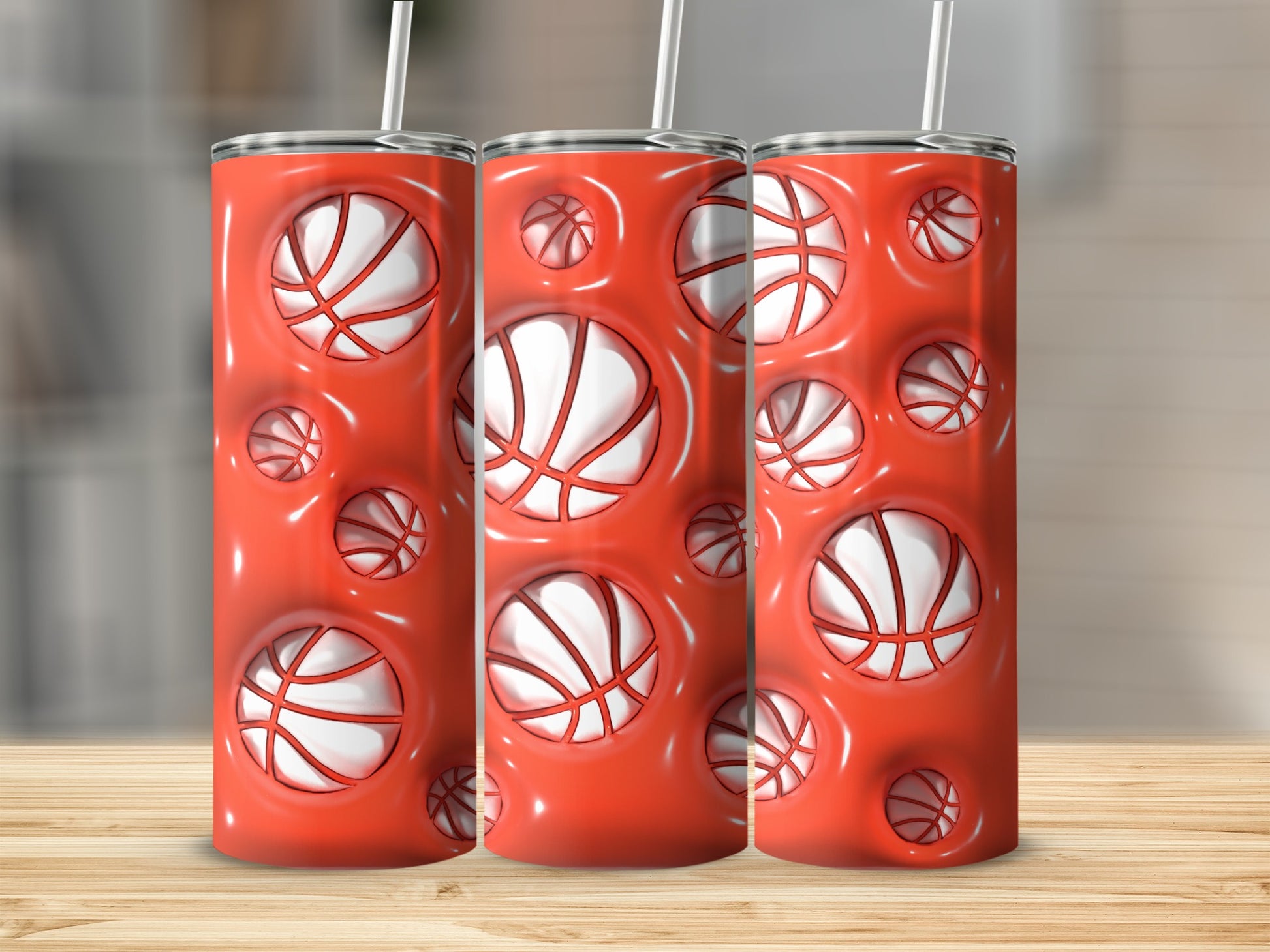 Three tall cylindrical tumblers with a repeating pattern of basketballs in recessed circles.