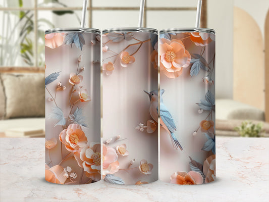 Three tumblers with floral and bird designs on a marble countertop.
