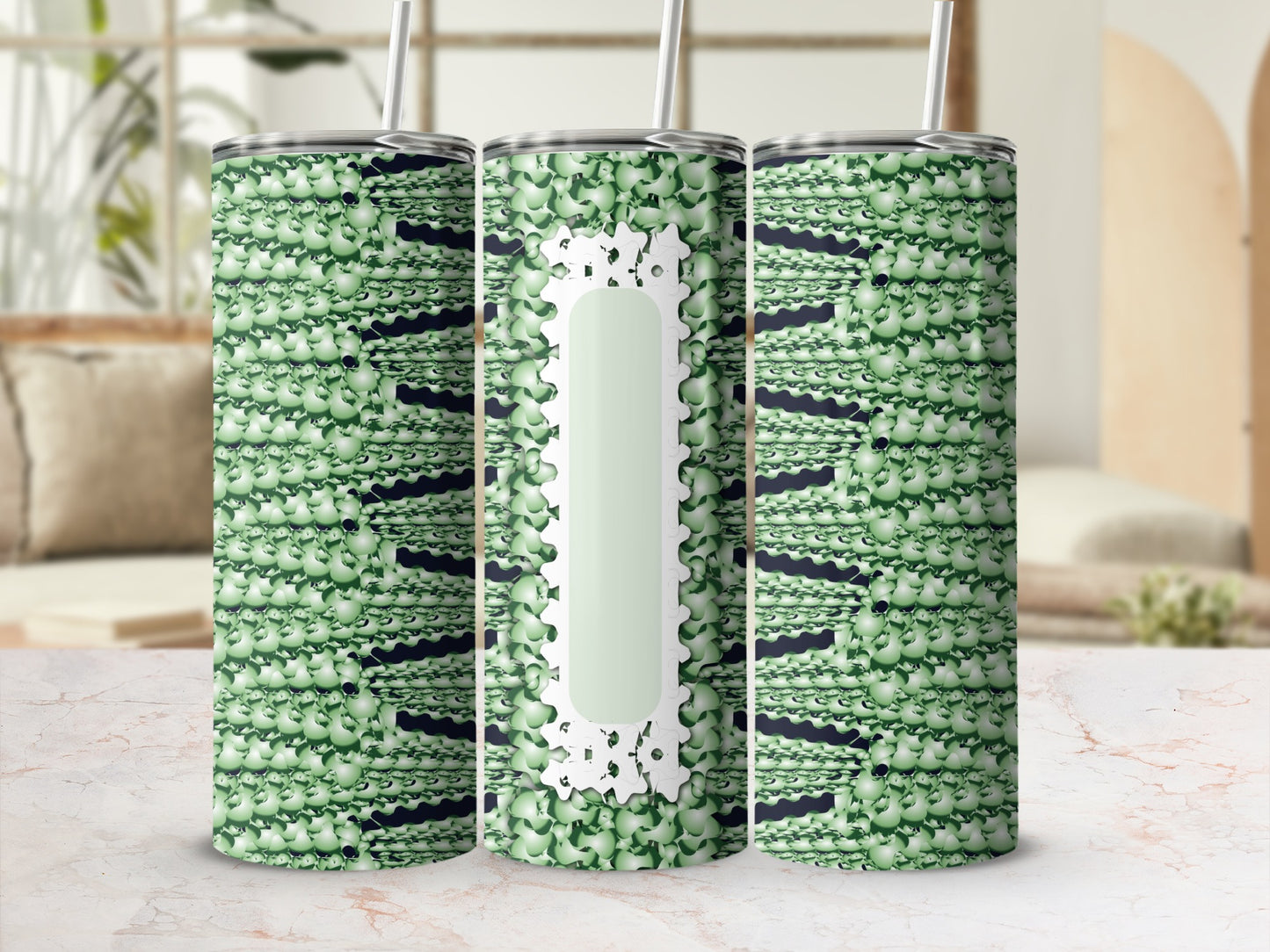 Three green patterned tumblers with white floral accents and straws.