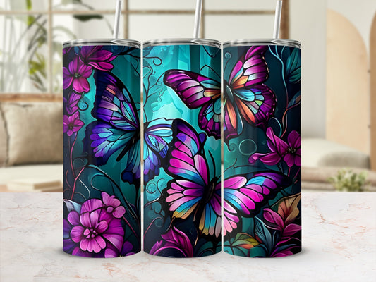 Three tumblers with colorful butterfly and floral designs on a teal background.