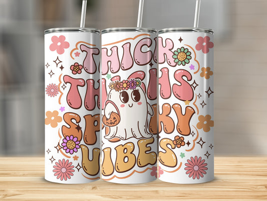 Tumbler with "Thick Thighs Spooky Vibes" text, ghost holding pumpkin, and floral graphics.