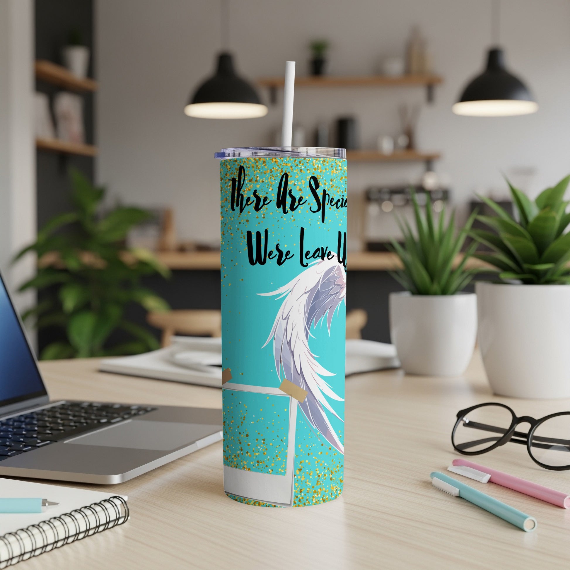 Turquoise tumbler with gold glitter, angel wings, and text.