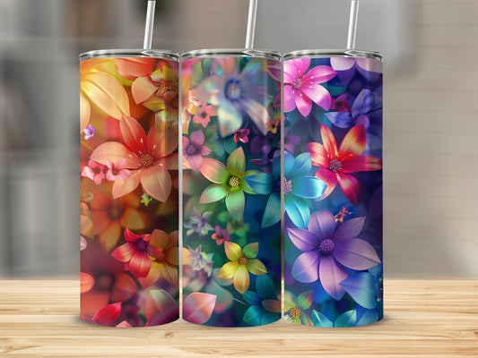 Three tumblers with vibrant floral designs in warm and cool color gradients.