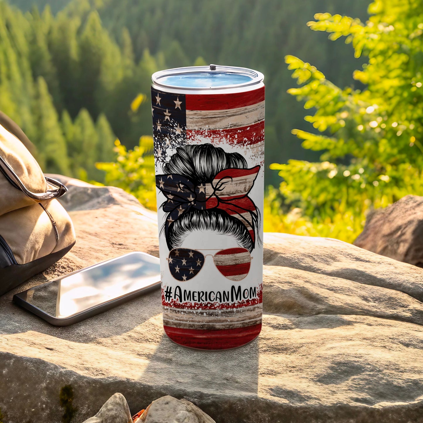 American flag tumbler with messy bun and sunglasses, #AmericanMom text.