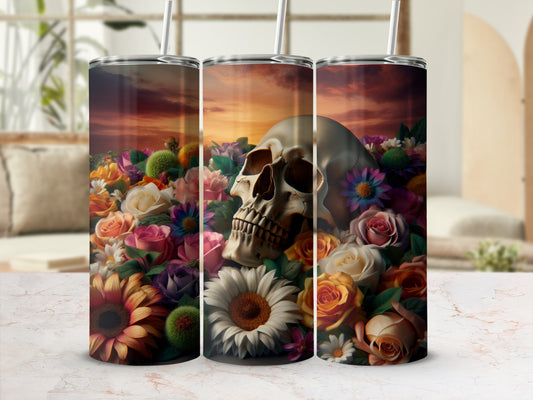 Tumbler with skull and colorful flowers at sunset.
